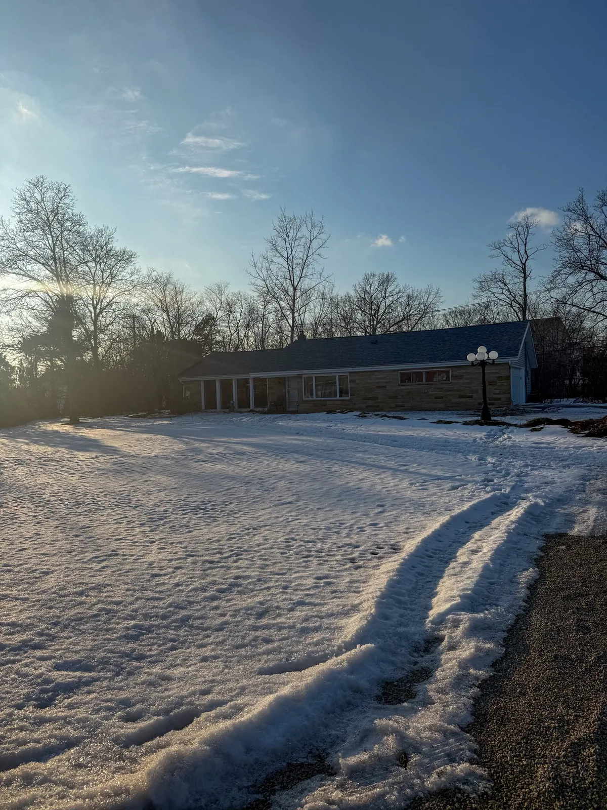 Ranch home with new roof at winter sunrise in rural Napoleon area