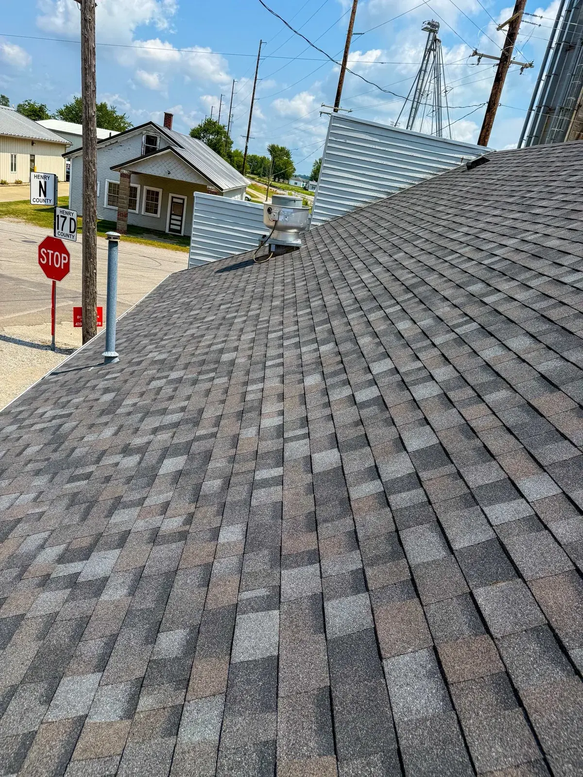 Close-up of aged shingles showing wear near a roofline